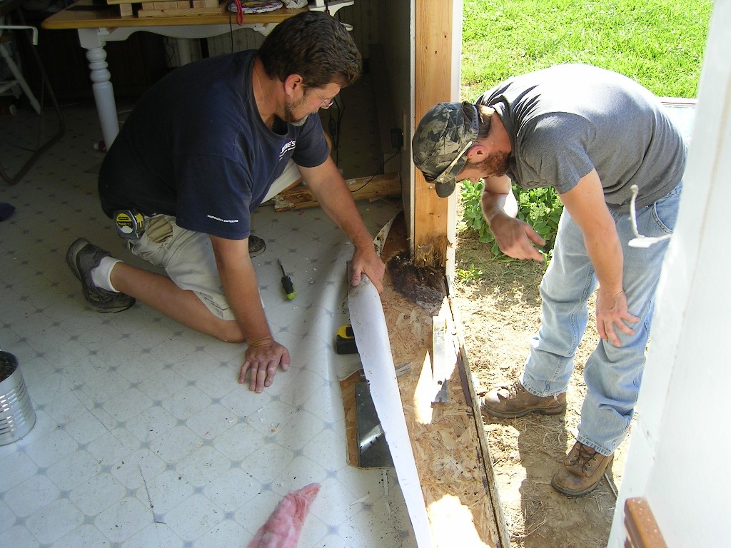 Contractors working on my rotten door frame